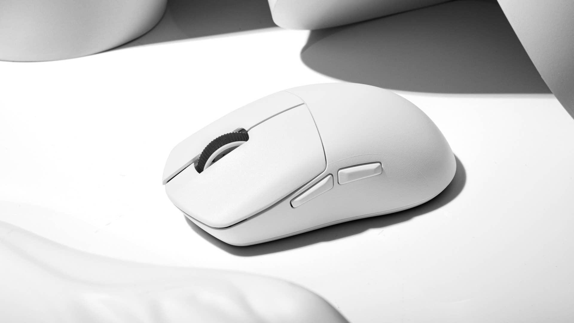 lemokey g1 gaming mouse in white on a white desk