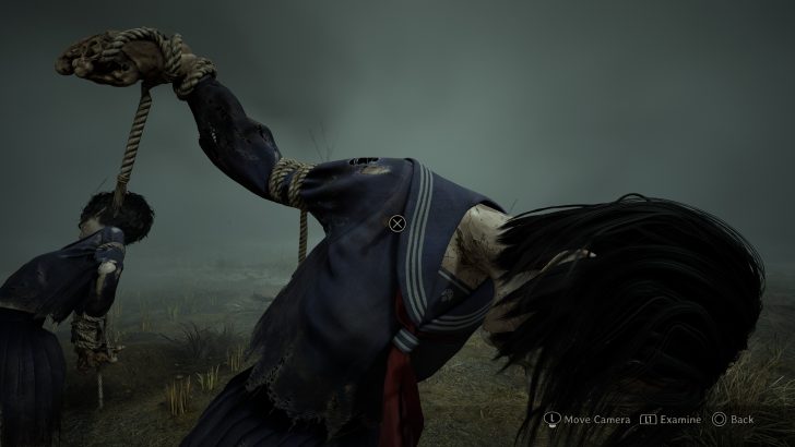 The screen displays a game scene with two figures bound by ropes in a foggy landscape, showing “Move Camera,” “Examine,” and “Back” controls.