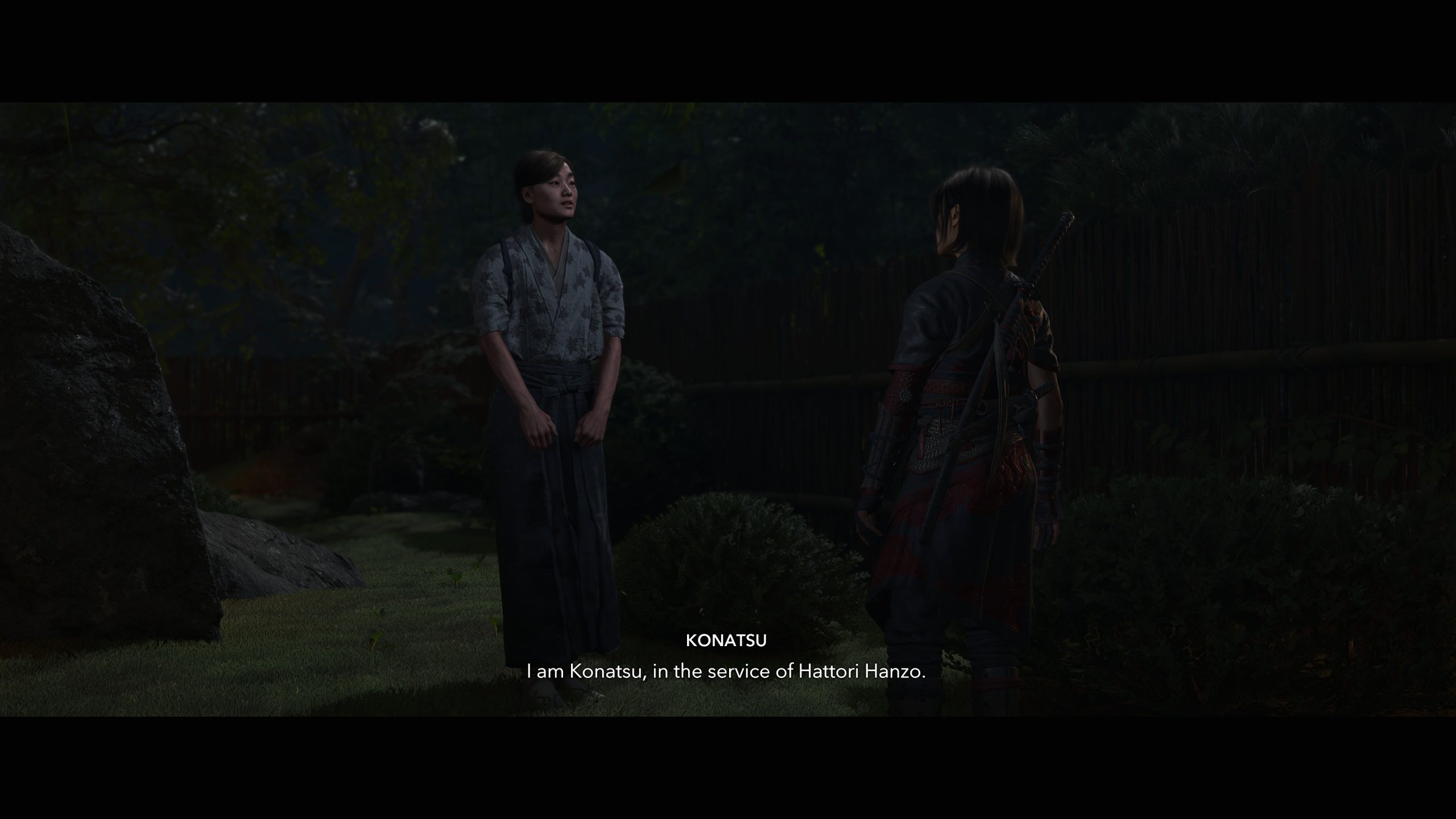 Two characters in Assassin's Creed Shadows: Claws of Awaji stand in a garden at night with the on-screen text: I am Konatsu, in the service of Hattori Hanzo.