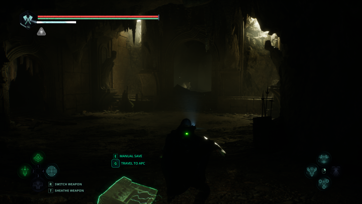 A video game screenshot showing a character in a dark cave with on-screen text saying MANUAL SAVE and TRAVEL TO APC.