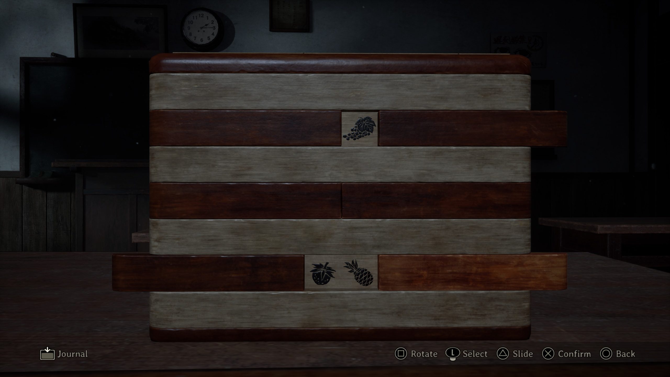 Puzzle box with fruit symbols in a dimly lit room, UI reads Journal and includes controls for rotate and slide.