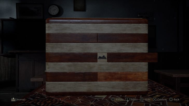 Wooden puzzle box with book icon and UI text: Rotate, Select, Slide, Confirm, Back, Journal.