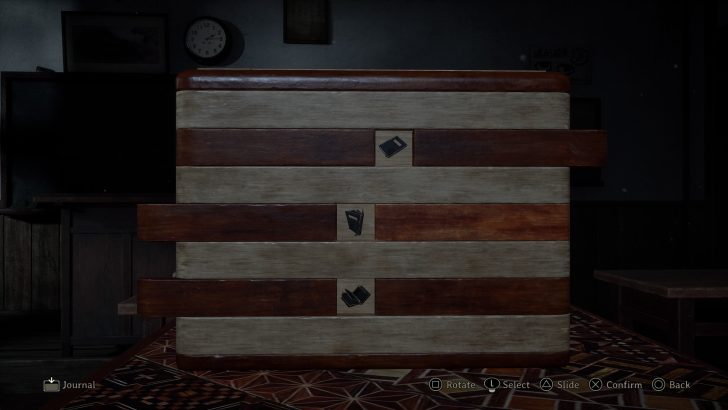Wooden puzzle box with book symbols on a screen showing Journal, Rotate, Select, Slide, Confirm, Back.