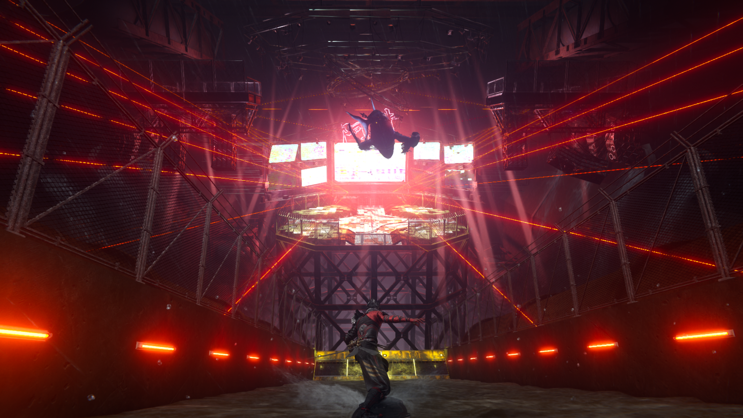 Person in armor points gun in industrial arena with red laser beams and large screens displaying glitching graphics.