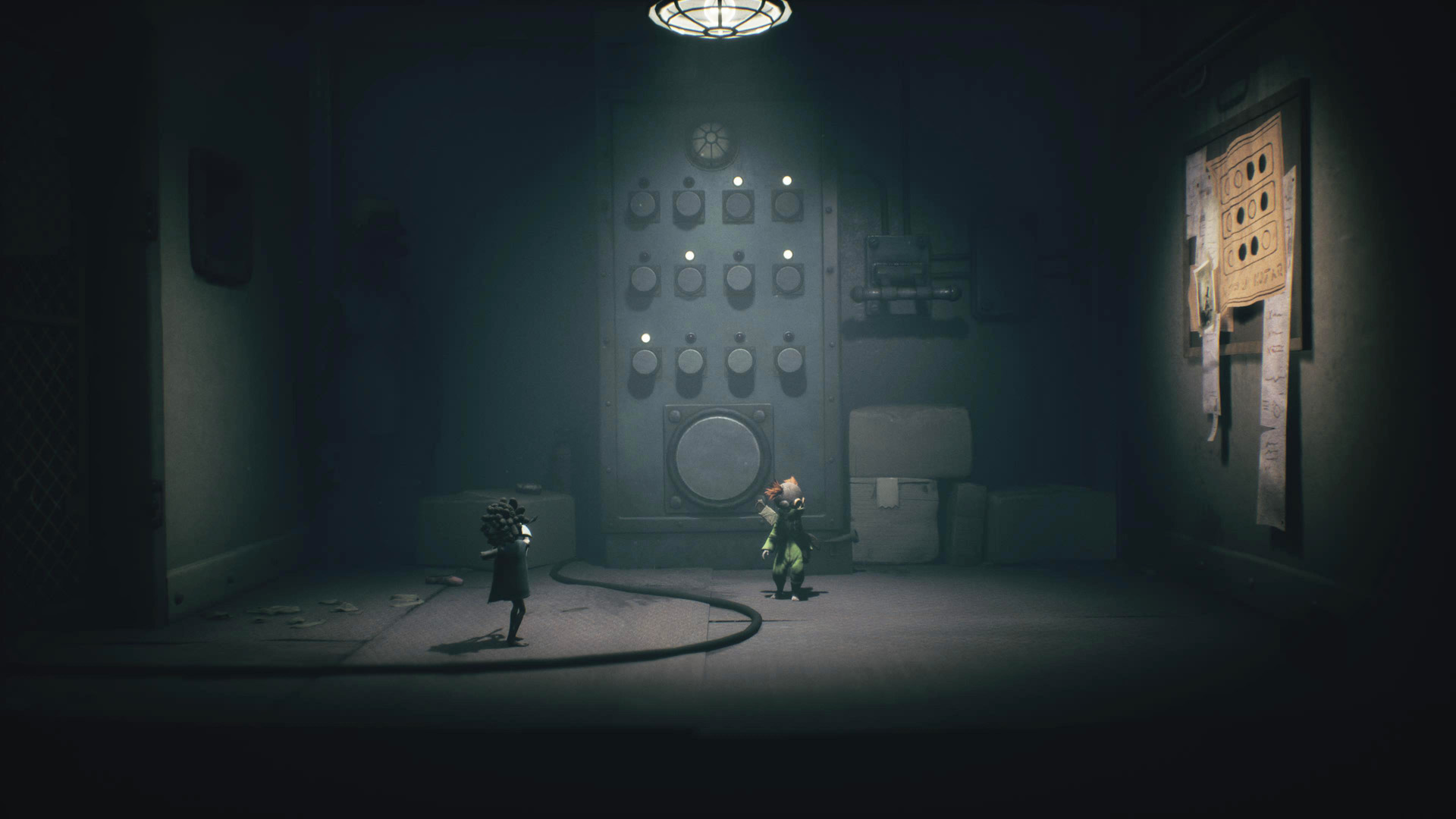 Two characters stand in a dimly lit room with a large control panel and a wall covered with notes.
